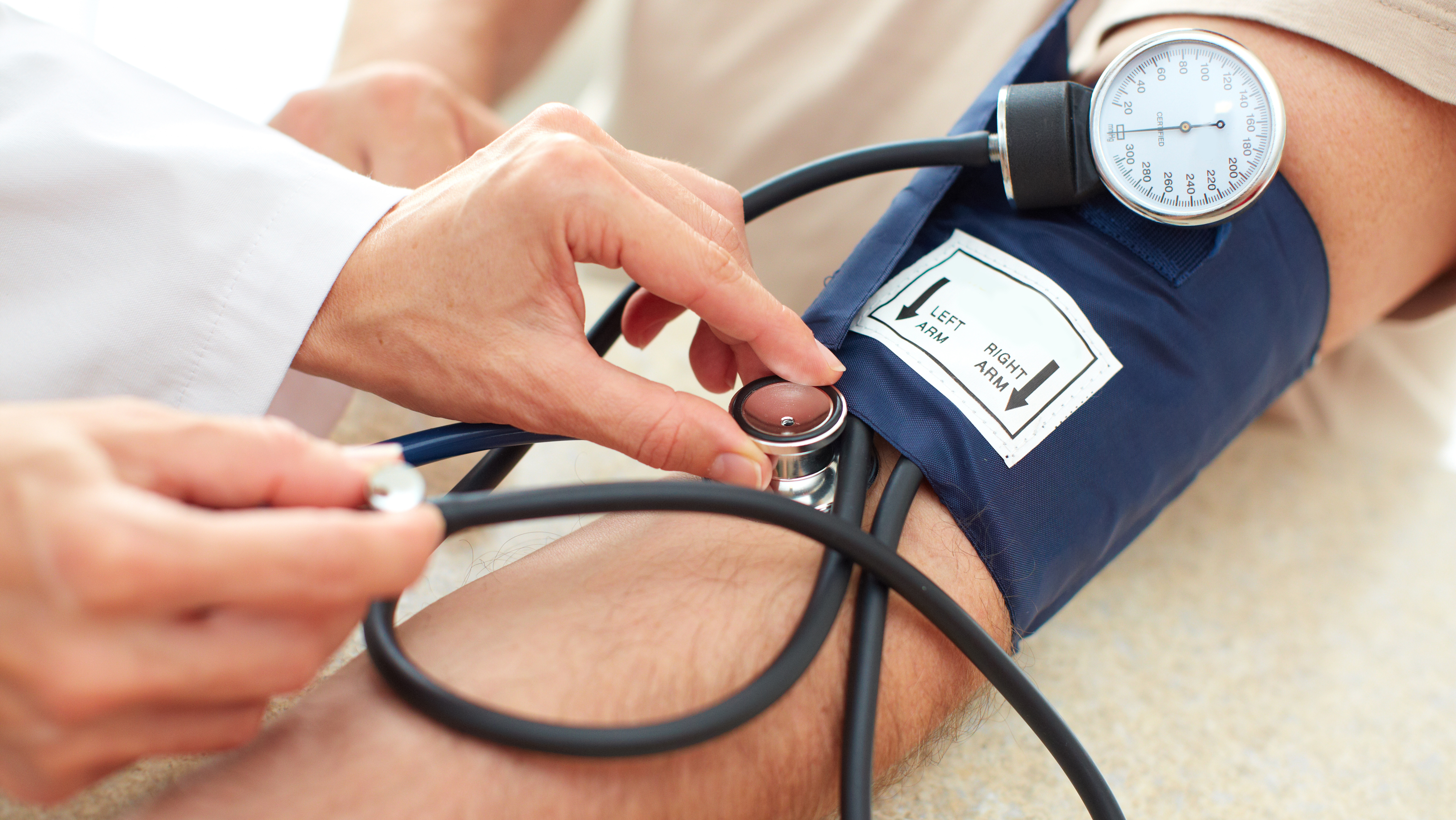 A doctor checking a patients blood pressure