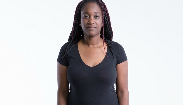 Participant Danielle stands facing the camera wearing a black shirt.