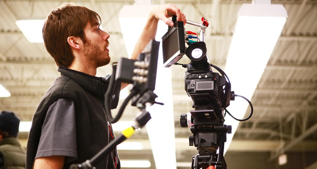 Cameraman shooting film scene with camera