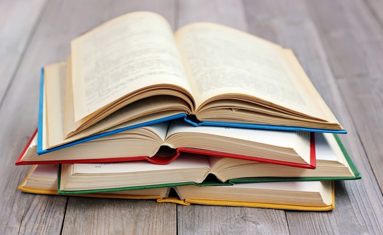 Three open books on the floor