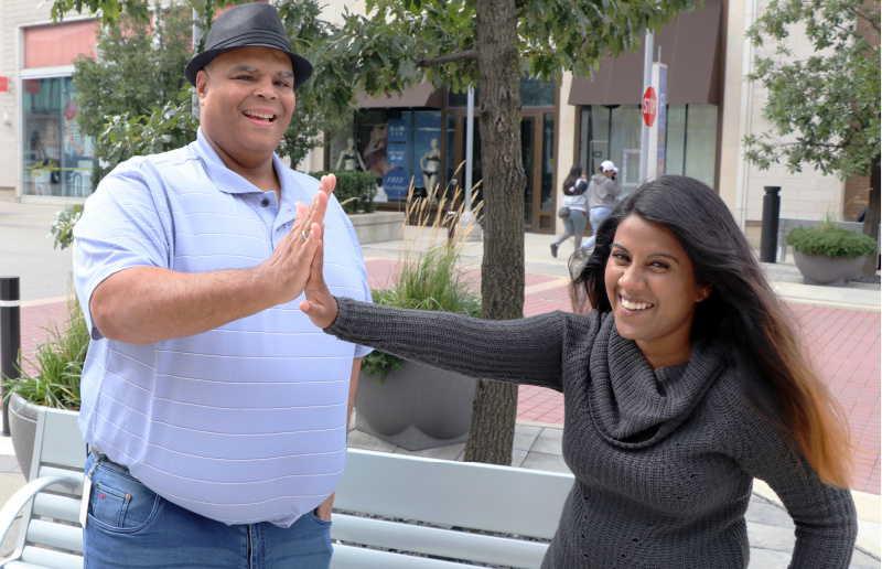A man and woman high-five each other.