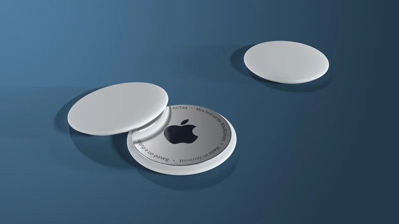 Three white circular plastic tags. One has the Apple logo. 