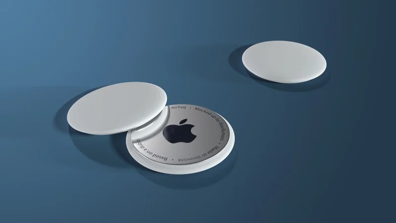 Three white circular plastic tags. One has the Apple logo.