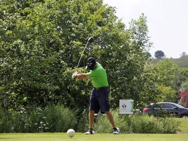 A man teeing off in blind golf