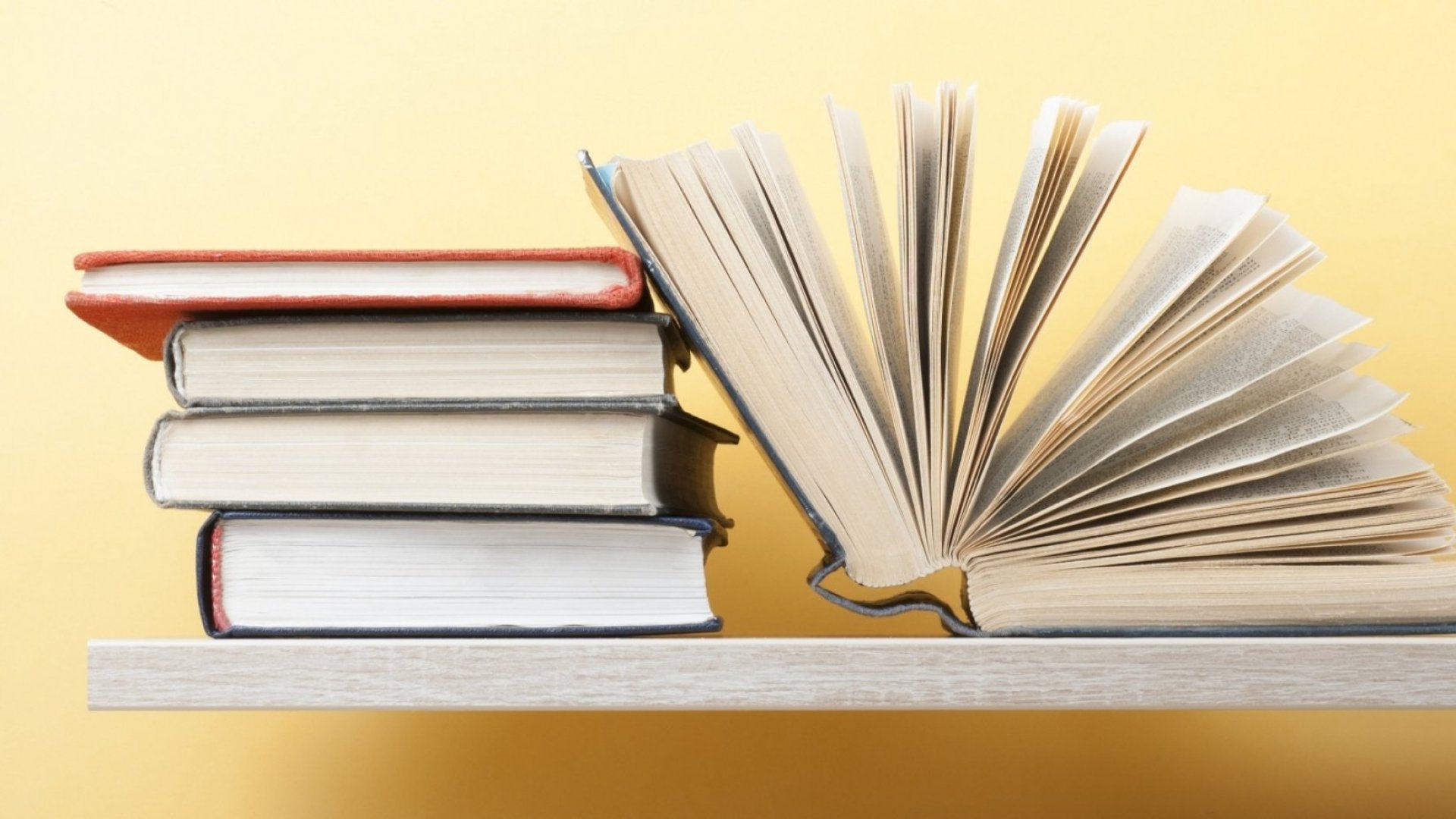 An open book on a bookshelf