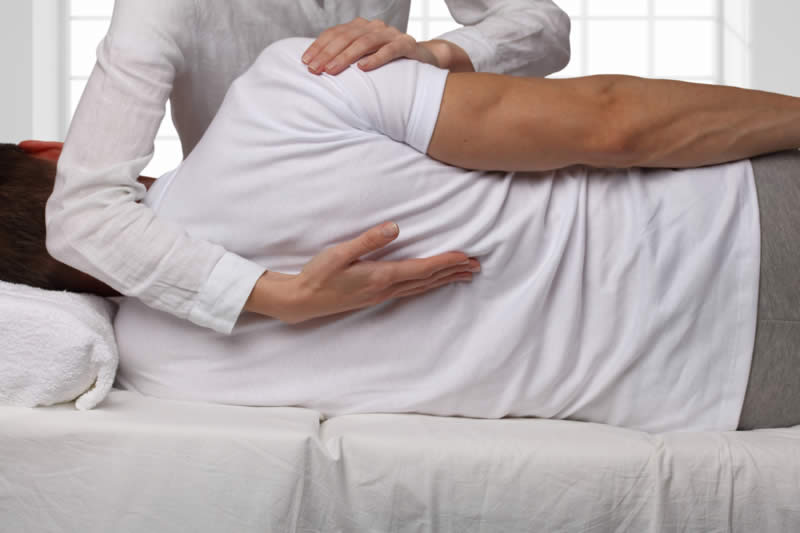 A man gets adjusted at the chiropractor