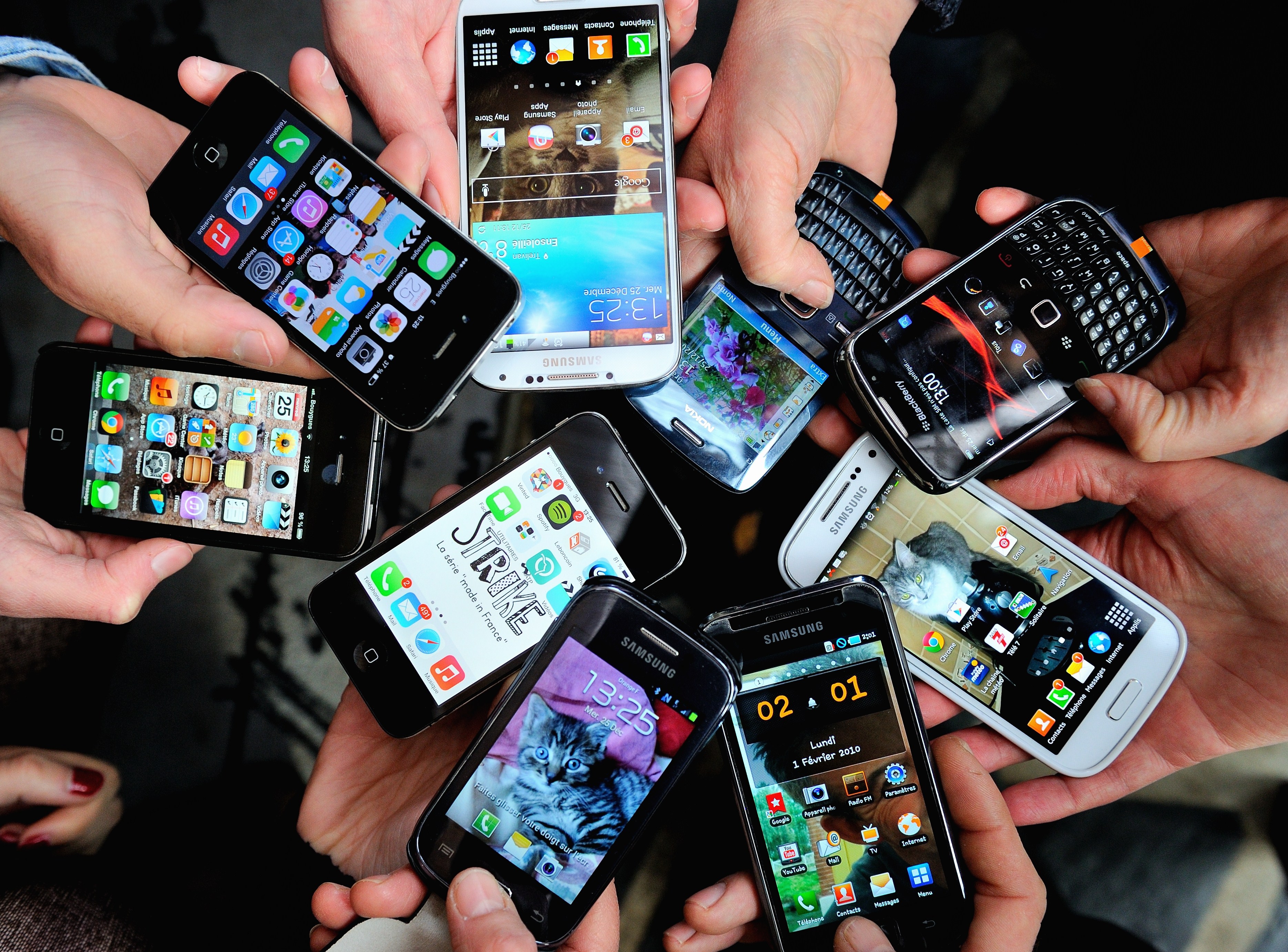 A group of people holding their smartphones