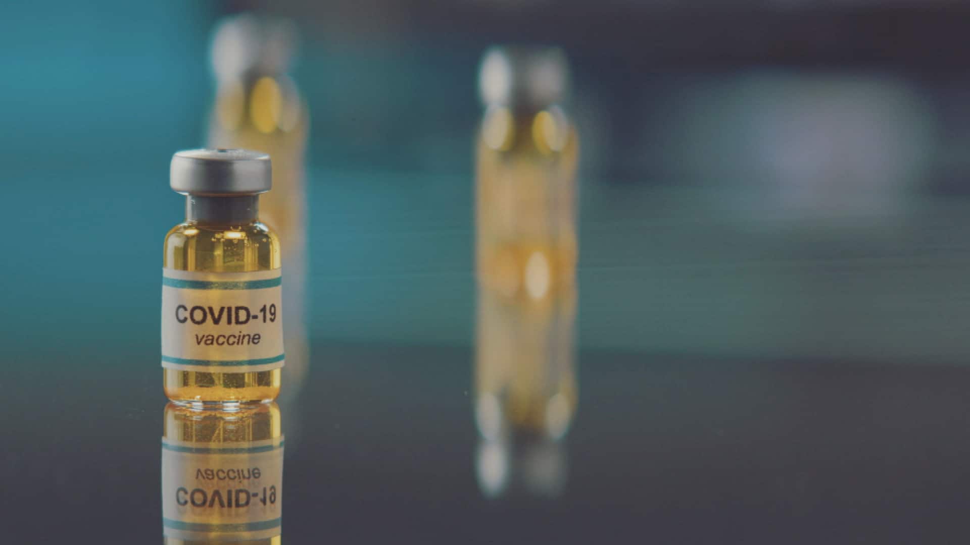 A close up of vaccine bottles on a table.