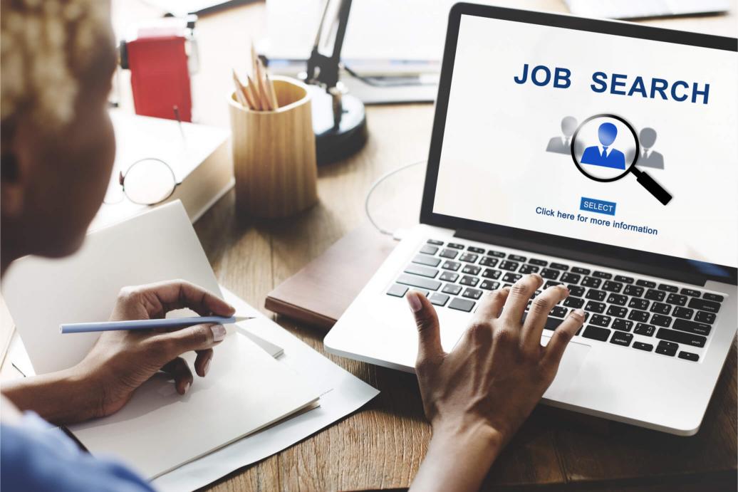 A person looking for a job on a computer 