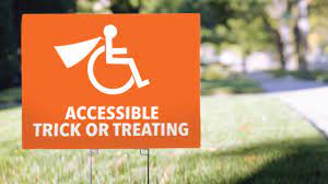 The image shows an orang lawn sign with a wheel chair logo that says, "Accessible Trick or Treating."