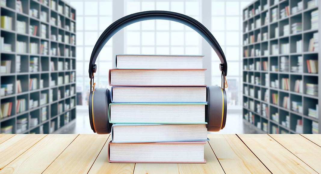 A stack of books with headphone on top