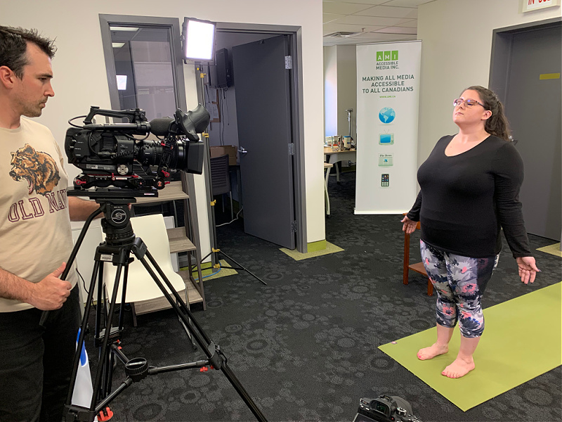 Jillian Gillis stands on a yoga mat, leaning back slightly.