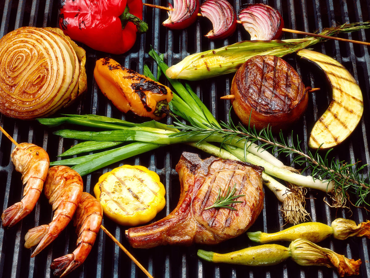 Various meats and veggies grilled on a BBQ