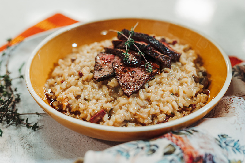 Seared venison on a bed of risotto.