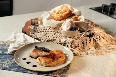 A plate with salmon and bannock placed on it.