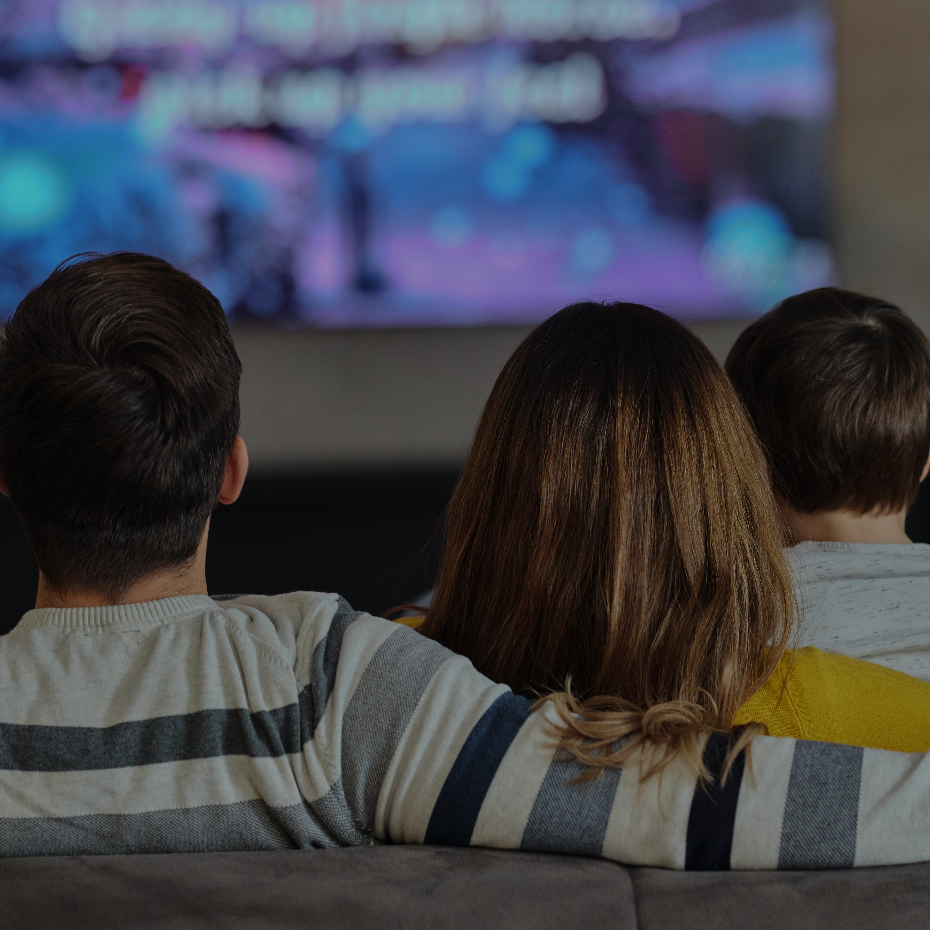 A family watches a television set.