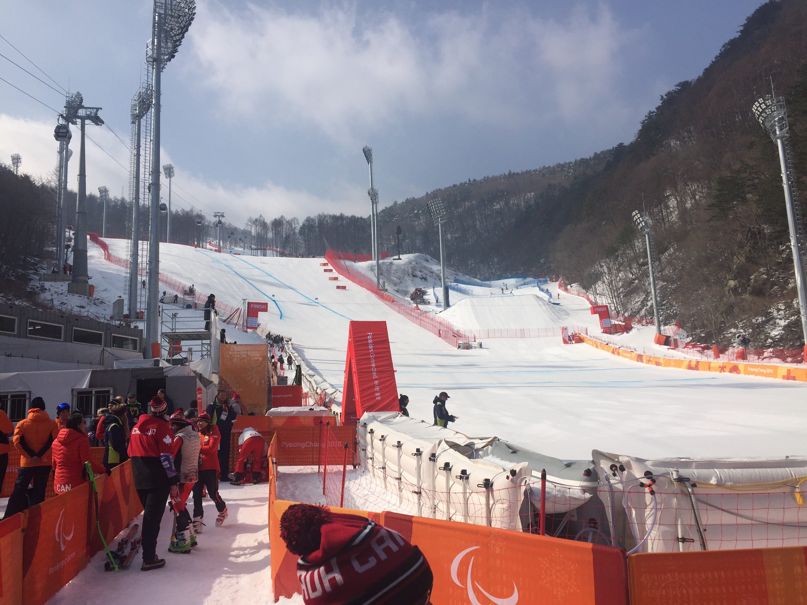 View of the finish line from Media Mixed Zone, broadcasters and personnel looking on. 