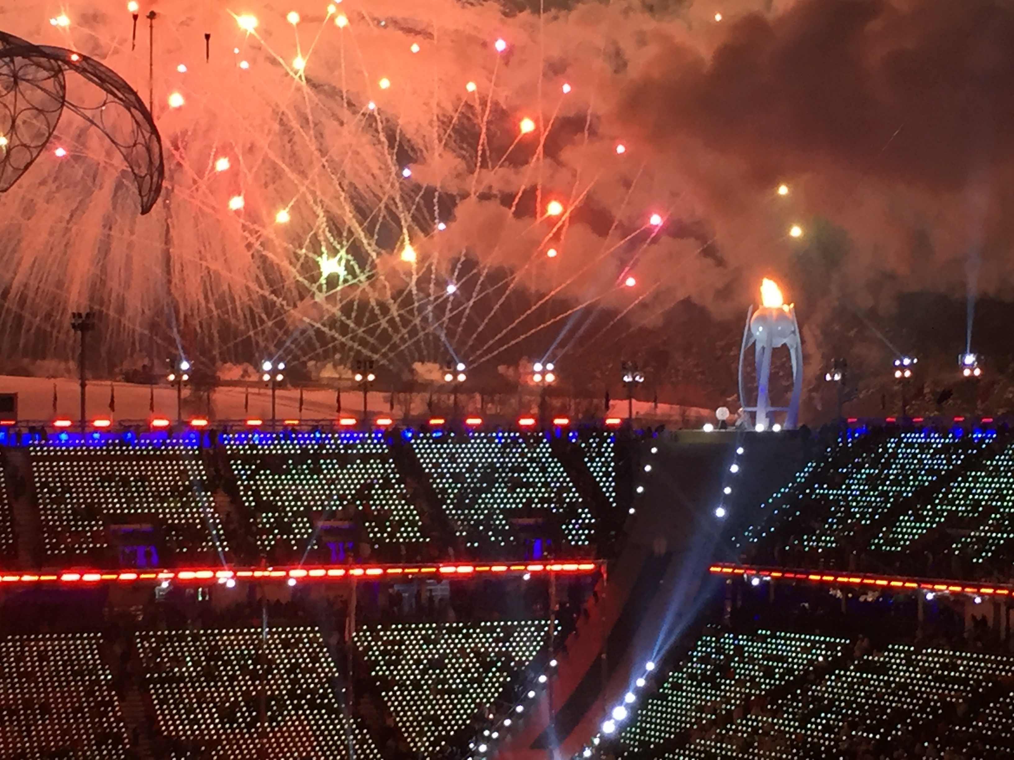 As fireworks explode in orange hues, the Paralympic cauldron burns bright. 
