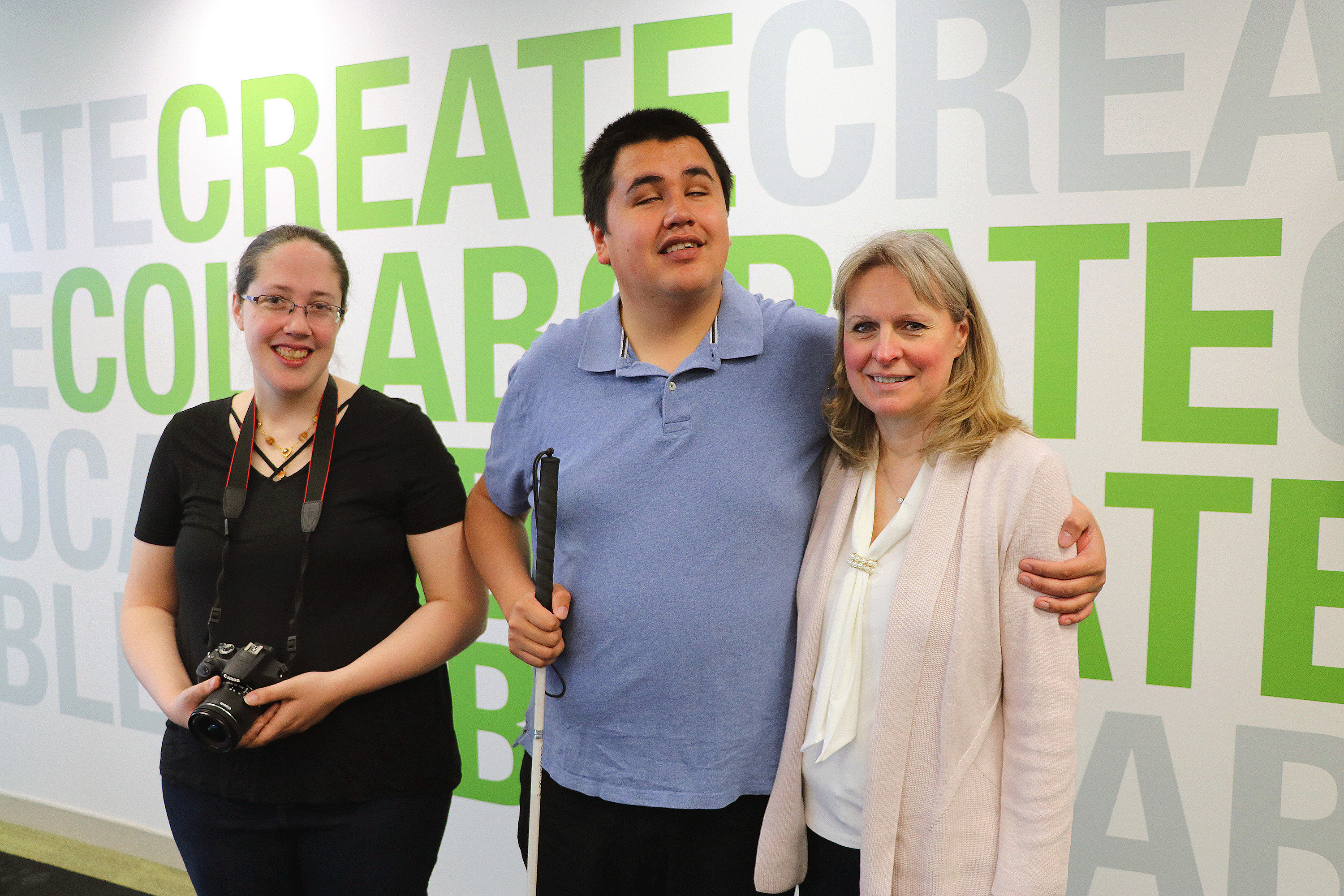 JR poses with his wife and Marianne, community reporter program manager