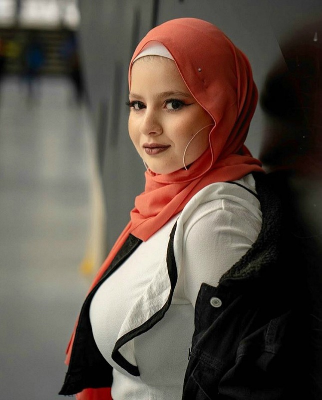 A woman smiles into the camera.