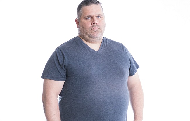 Participant Rick stands facing the camera wearing a grey shirt.