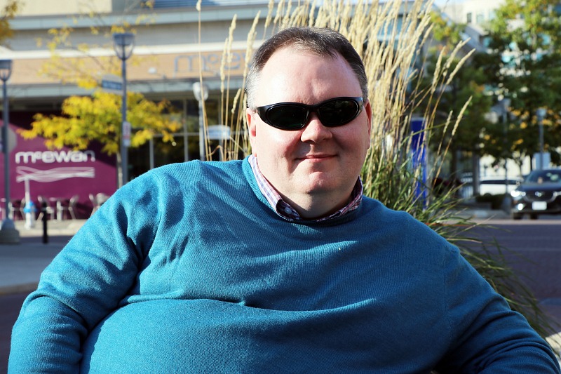 A man sits on a bench.