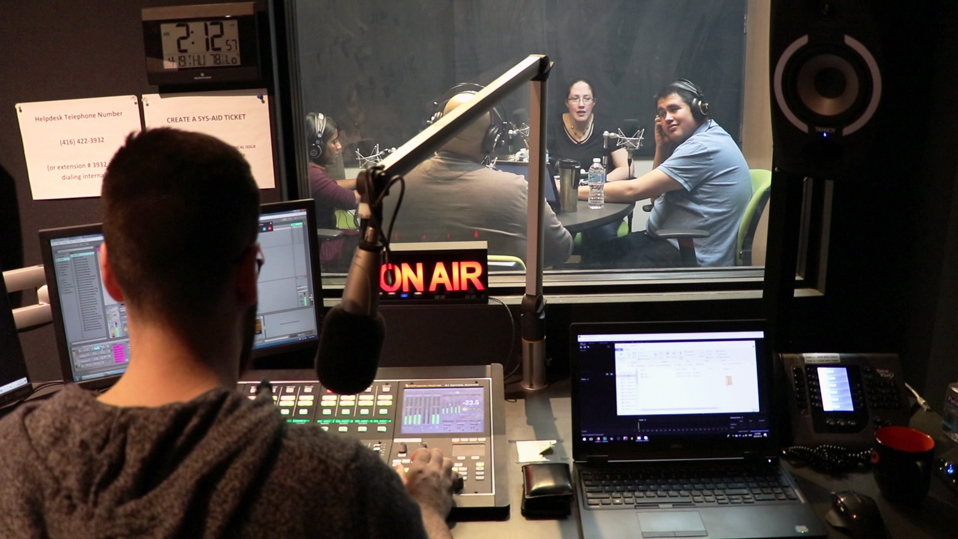 A view from inside the control room looking in to the studio 