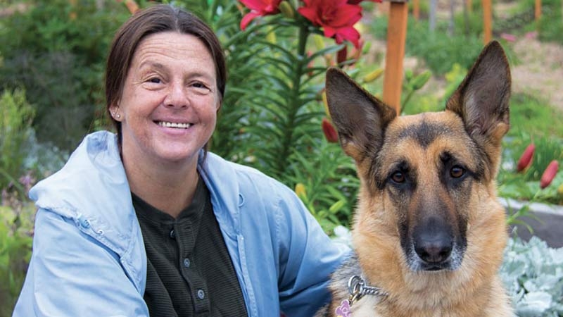 Portrait of Milena and her guide dog Louis.