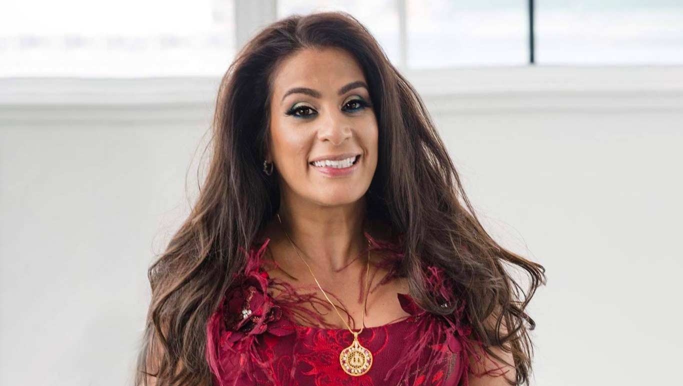 Maysoon Zayid smiles into the camera.